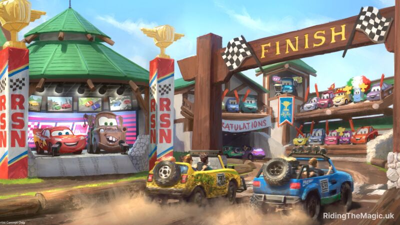 Two cars cross a finish line in a race whilst Cars characters from the film watch from the side lines