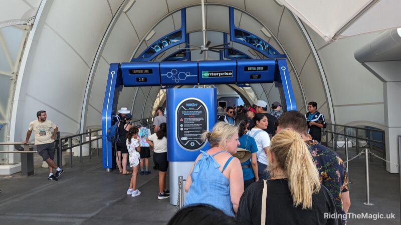 People queue at the entrance portal to TRON