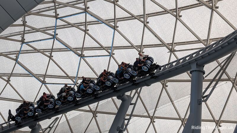 People ride Tron rollercoaster under its iconic patterned cannopy