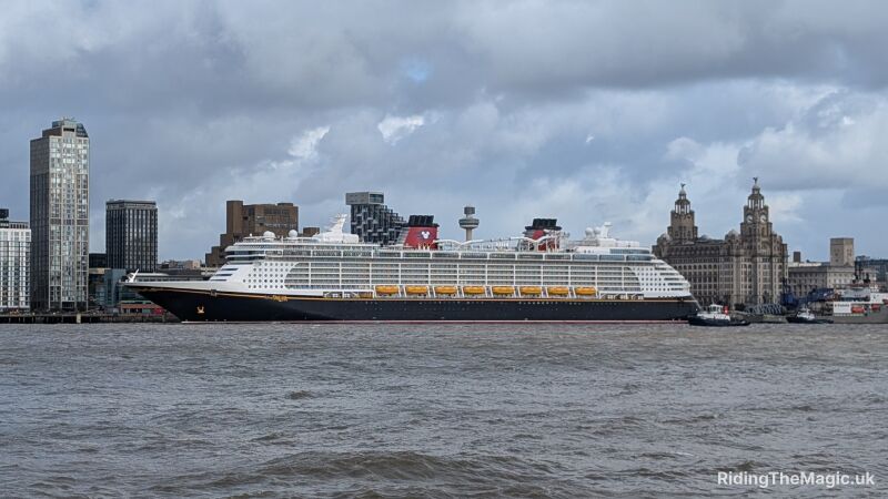 The Disney Dream cruise ship docked in Liverpool with the Liverpool skyline behind