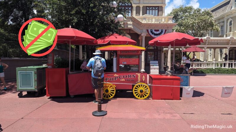A man stands in line for popcorn at a Main Street popcorn stand