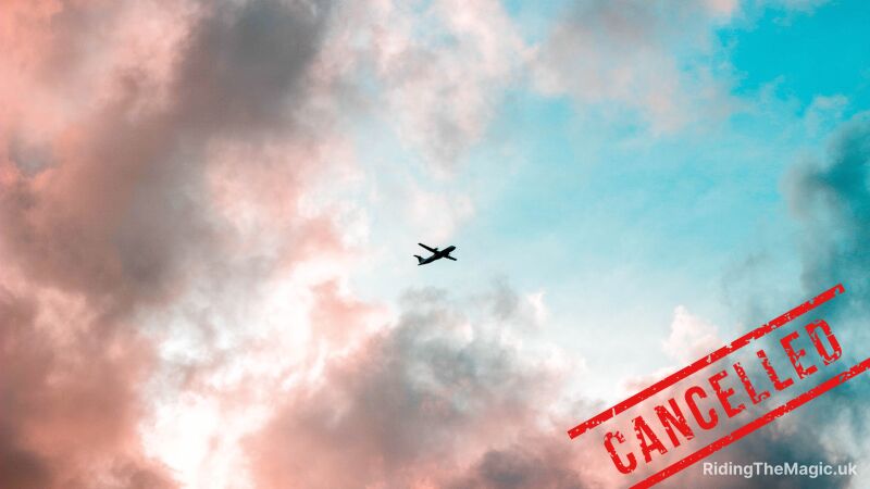 An airplane flying through a pink and blue sky with the word "cancelled" written below