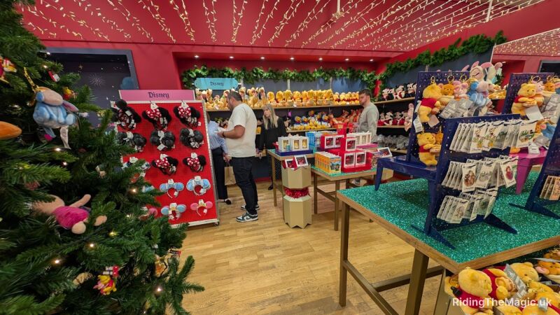 Disney merchandise store with Christmas decorations and people shopping for gifts