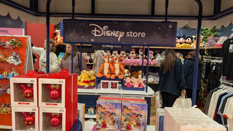 A Disney store with Mickey Mouse plush toys, Mickey's Christmas Carol books, and Mickey Mouse ornaments