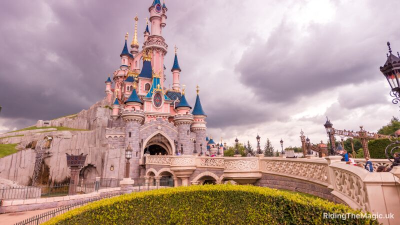 Disney castle with blue sky and clouds in the background