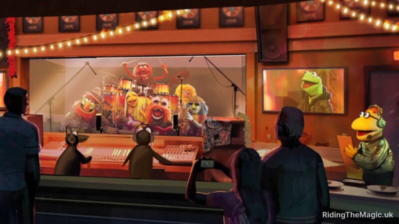 A group of people watch a Muppets show on a screen inside a recording studio