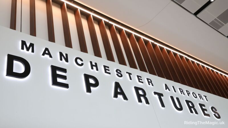 A sign at Manchester Airport that reads "Manchester Airport Departures"