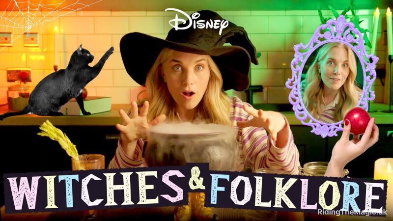 A woman wearing a witch hat is making a potion with a black cat