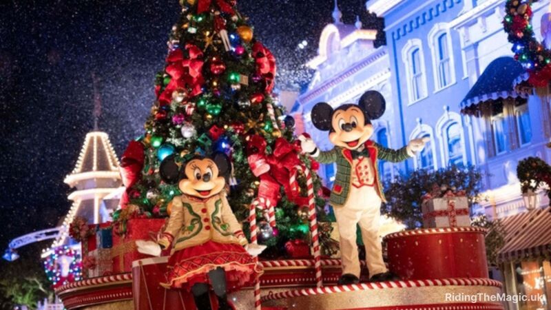 Mickey and Minnie Mouse characters in Christmas costumes standing in front of a Christmas tree