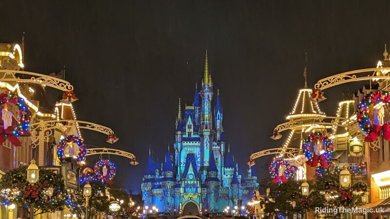 Disney World's Cinderella Castle is decorated for Christmas with lights and wreaths