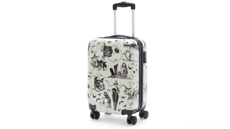 A black and white suitcase with a Nightmare Before Christmas theme on it