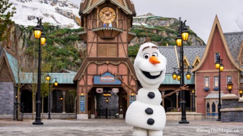 Olaf standing in front of a clock tower at Disney World