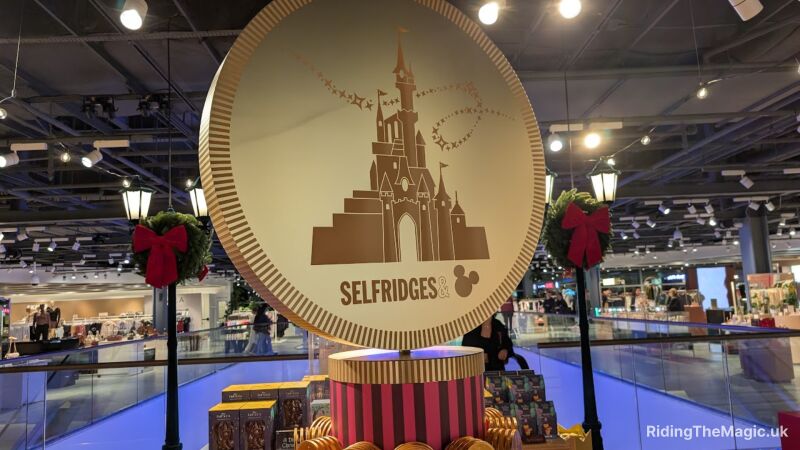 A circular display with the Selfridges logo and Disney Castle design inside a shopping mall
