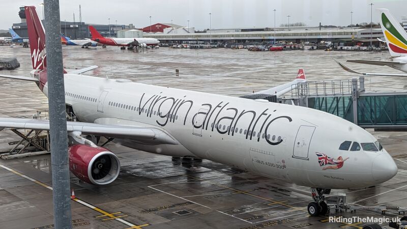 virgin Atlantic miss sunshine plane parked at terminal building