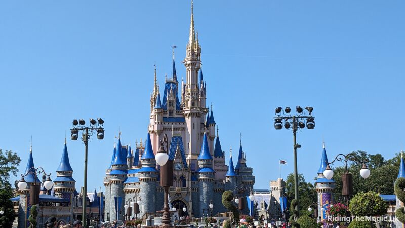 A blue and pink castle in front of a blue sky at Walt Disney World
