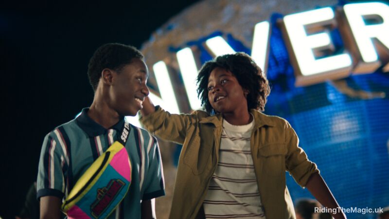 Two kids in front of a Universal Studios sign