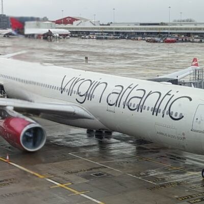 A Virgin Atlantic airplane is parked on the tarmac at an airport