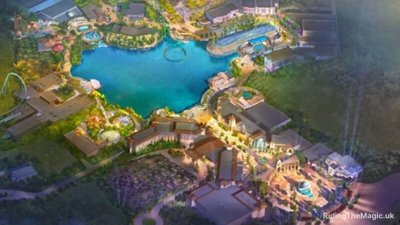 An aerial view of a resort with a lake, buildings, and a roller coaster