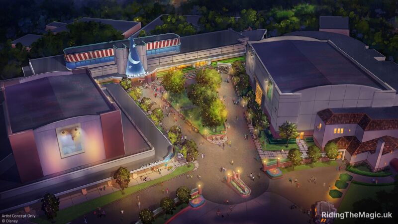 Artists concept v shaped path with lights on nighttime buildings around the path with opening at the bottom large blue and white wizard hat on building entrance at the top tress